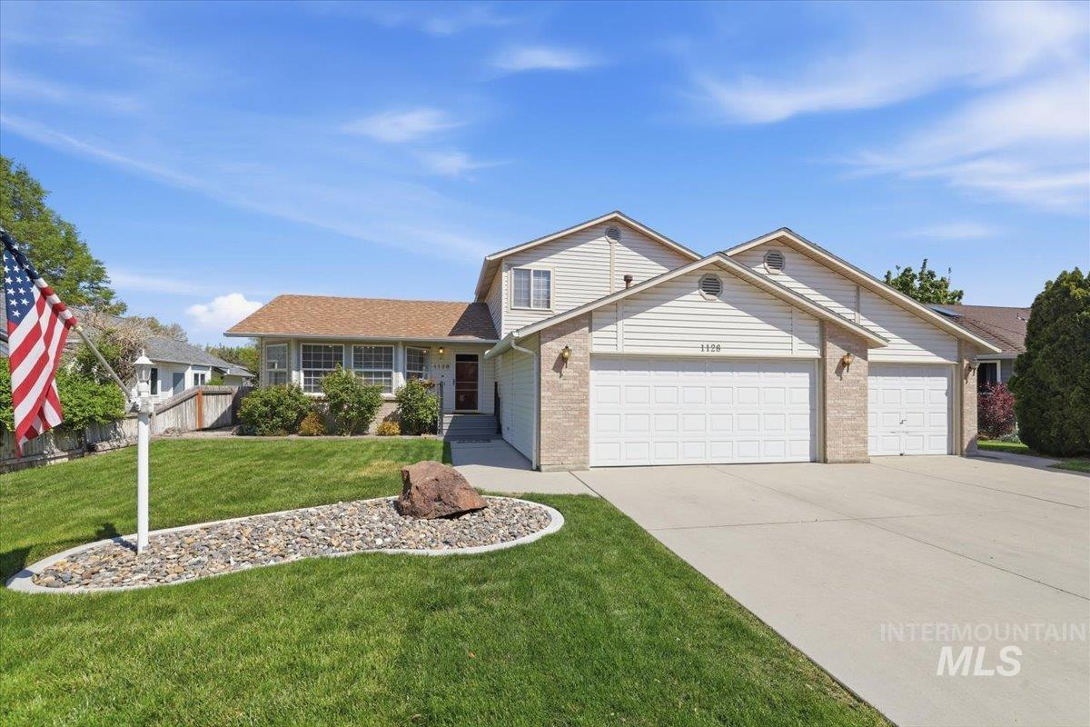 1128 West State Street Meridian, ID 83642 - Photo 4 of 50 Exterior featuring light-colored siding, brick accents, and a multi-car concrete driveway