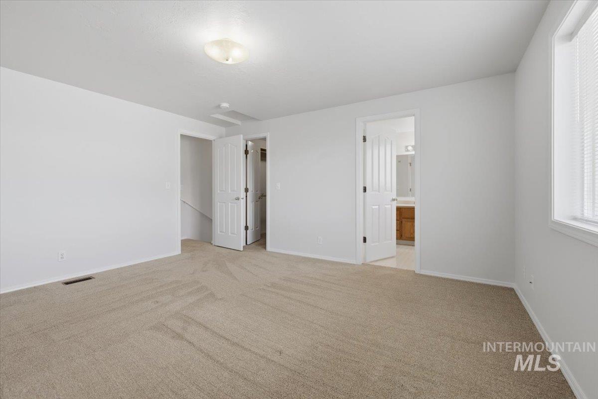 1128 West State Street Meridian, ID 83642 - Photo 40 of 50 Spacious room with light-toned carpet flooring, white walls, and a ceiling-mounted light fixture