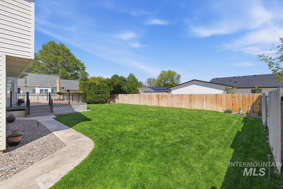 1128 West State Street Meridian, ID 83642 - Photo 47 of 50 Expansive green lawn with a wood privacy fence