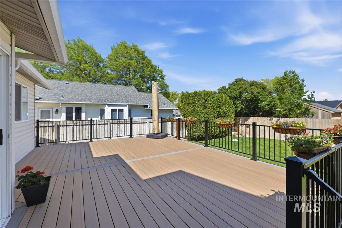 1128 West State Street Meridian, ID 83642 - Photo 48 of 50 Multi-level deck featuring composite decking and black metal railings with integrated planters