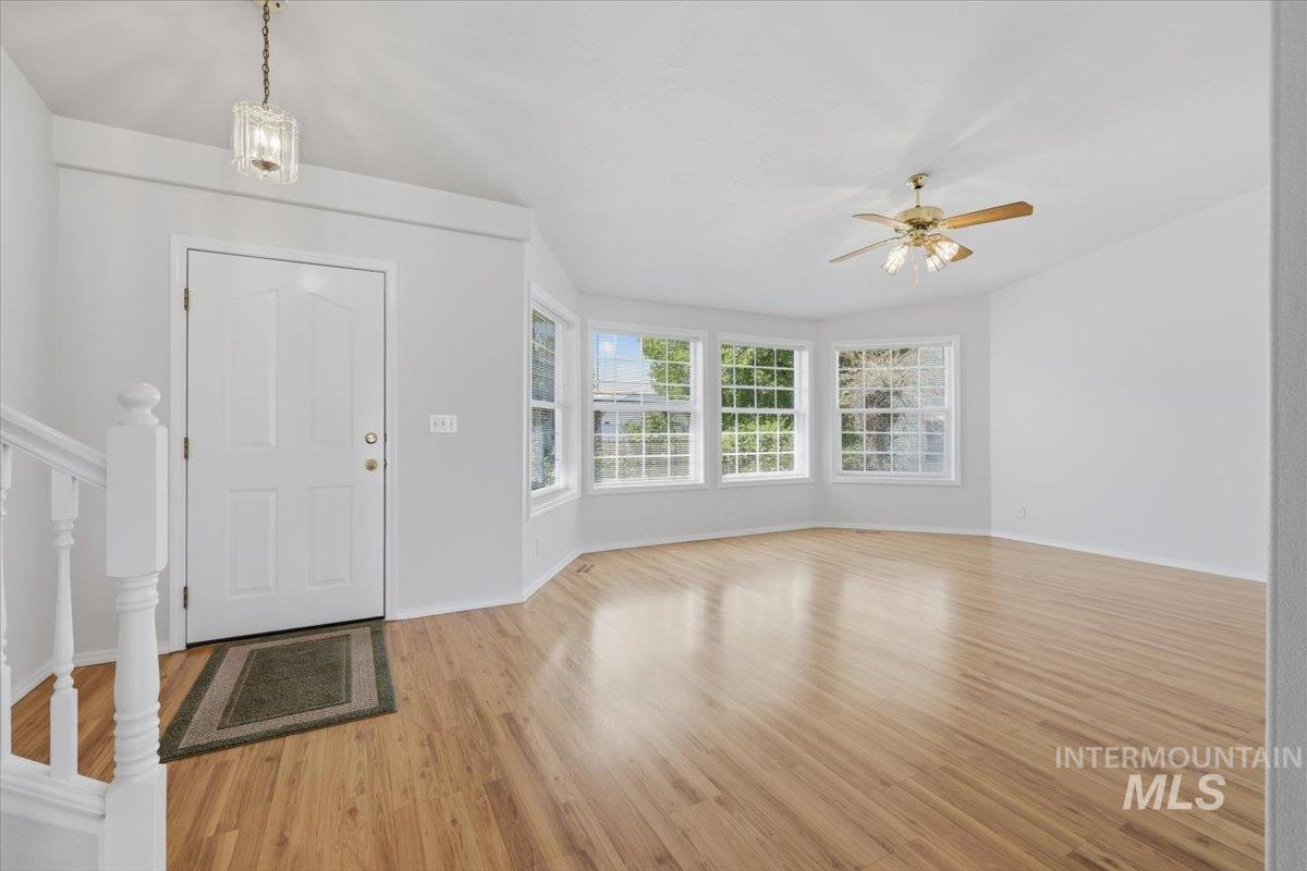 1128 West State Street Meridian, ID 83642 - Photo 7 of 50 Entry foyer with wood-finish flooring and a bay window featuring multiple paneled windows