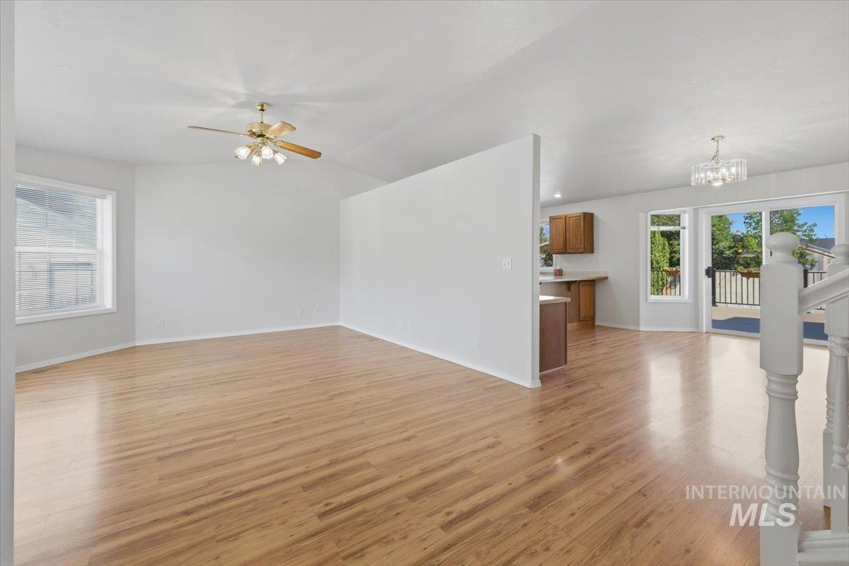 1128 West State Street Meridian, ID 83642 - Photo 8 of 50 Spacious interior featuring wood-finish flooring, vaulted ceilings, and ample natural light from multiple windows