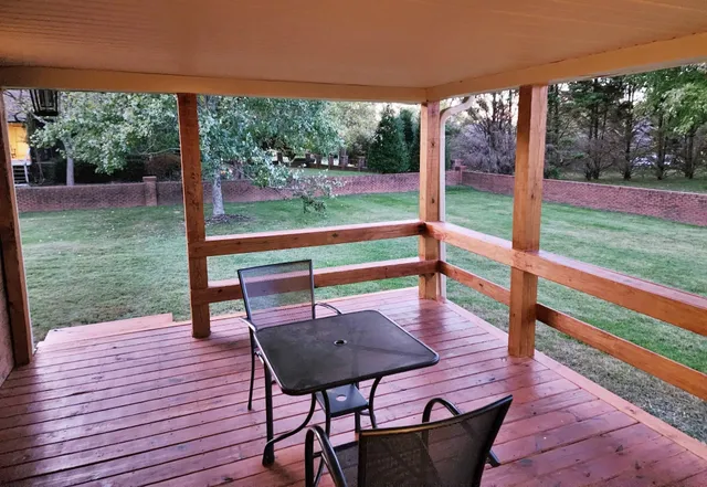 a view of a backyard with barn fence