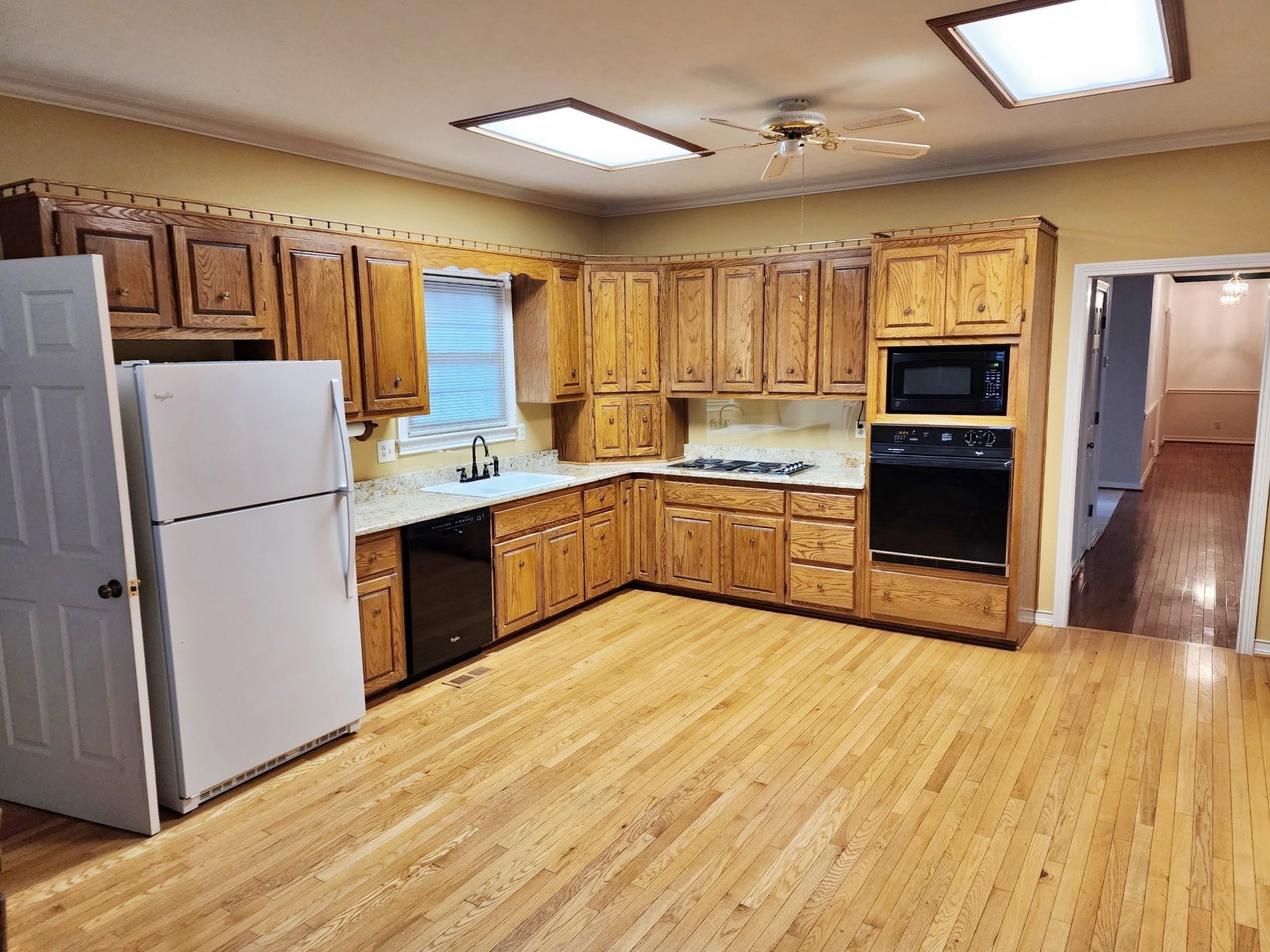 407 Tivoli Trail Springfield, TN 37172 - Photo 10 of 21 a kitchen with stainless steel appliances granite countertop a refrigerator a stove and a sink with wooden floor