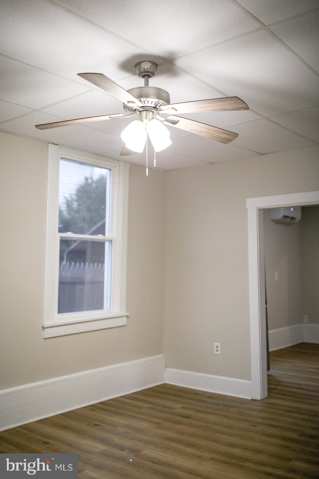179 Main Street Hartly, DE 19953 - Photo 20 of 43 a view of an empty room with wooden floor and a window