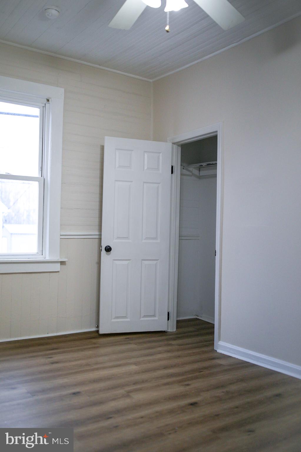 179 Main Street Hartly, DE 19953 - Photo 40 of 43 an empty room with wooden floor and windows