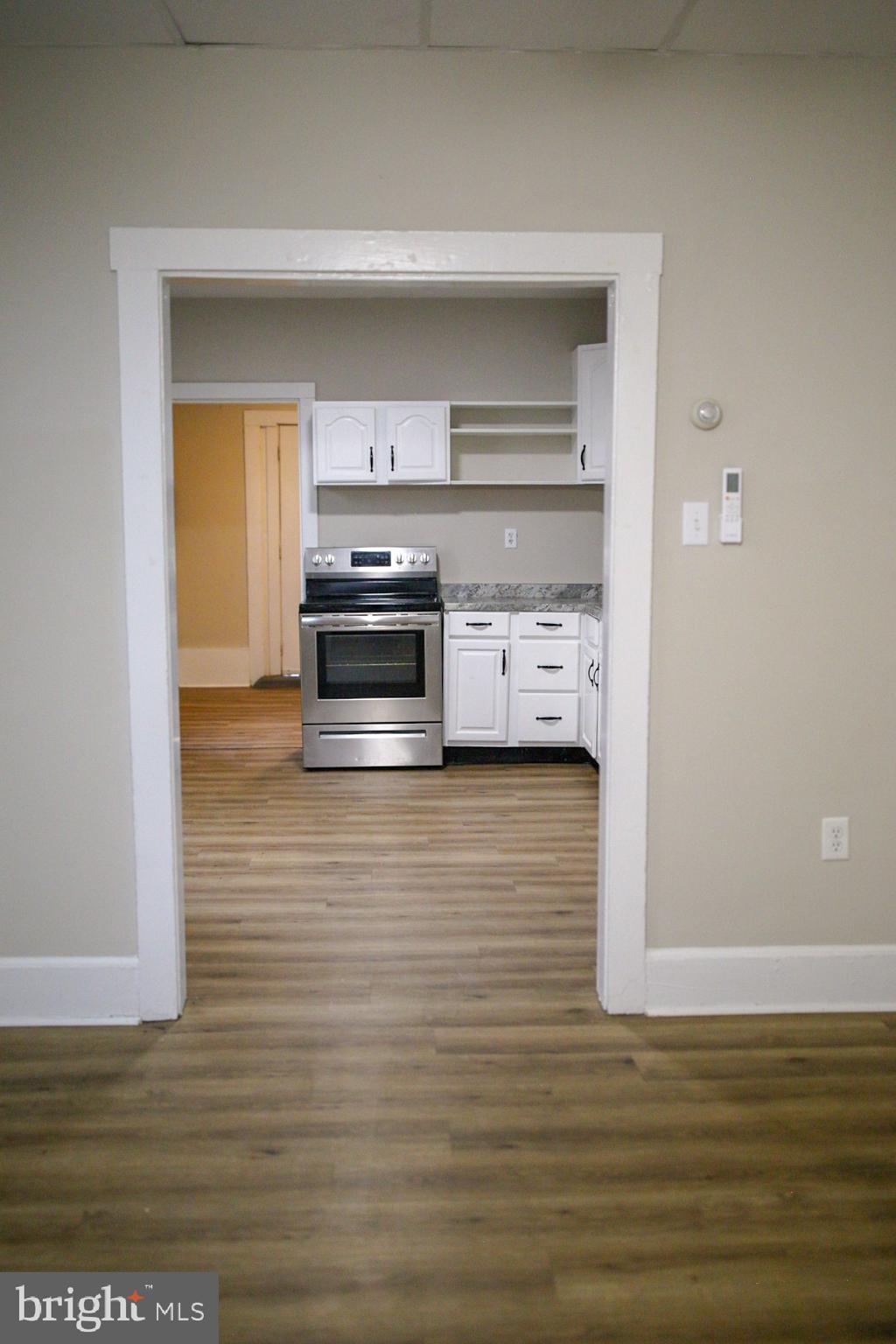 179 Main Street Hartly, DE 19953 - Photo 4 of 43 a kitchen with stainless steel appliances a refrigerator and a stove
