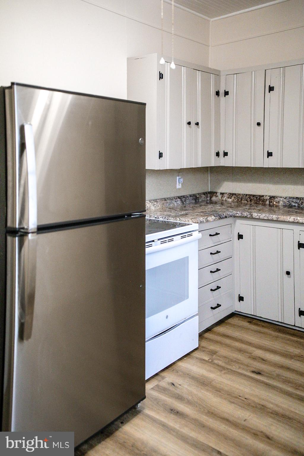 179 Main Street Hartly, DE 19953 - Photo 43 of 43 a white refrigerator freezer sitting in a kitchen