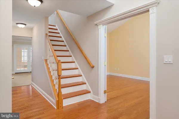 a view of a chandelier fan and wood floor