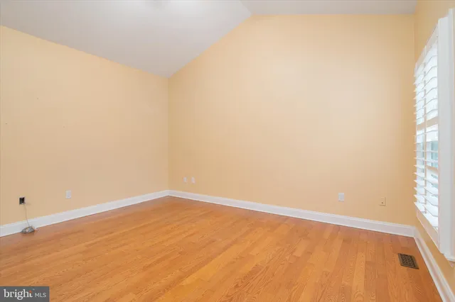 a kitchen with stainless steel appliances granite countertop a refrigerator a sink a stove a washer dryer and a cabinets