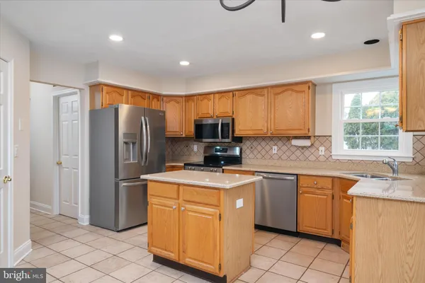 an empty room with windows and fireplace