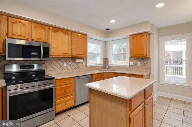 a view of empty room with wooden floor and windows
