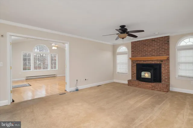 an empty room with a ceiling fan and window