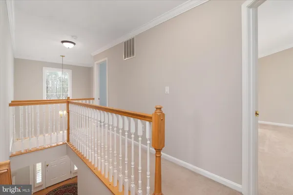 an empty room with chandelier fan
