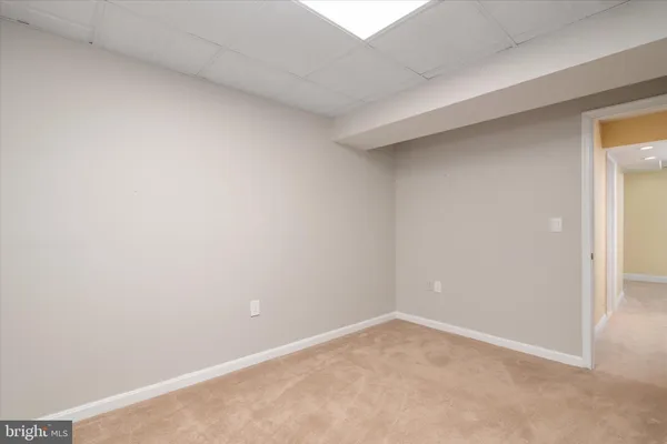 a view of a house with a big yard and sitting area