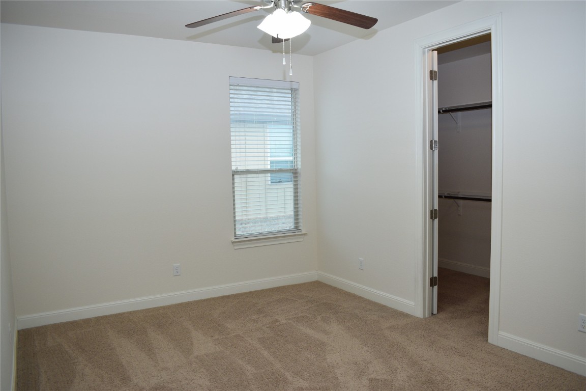 3001 Tempe Drive Cedar Park, TX 78641 - Photo 26 of 34 an empty room with windows and chandelier fan
