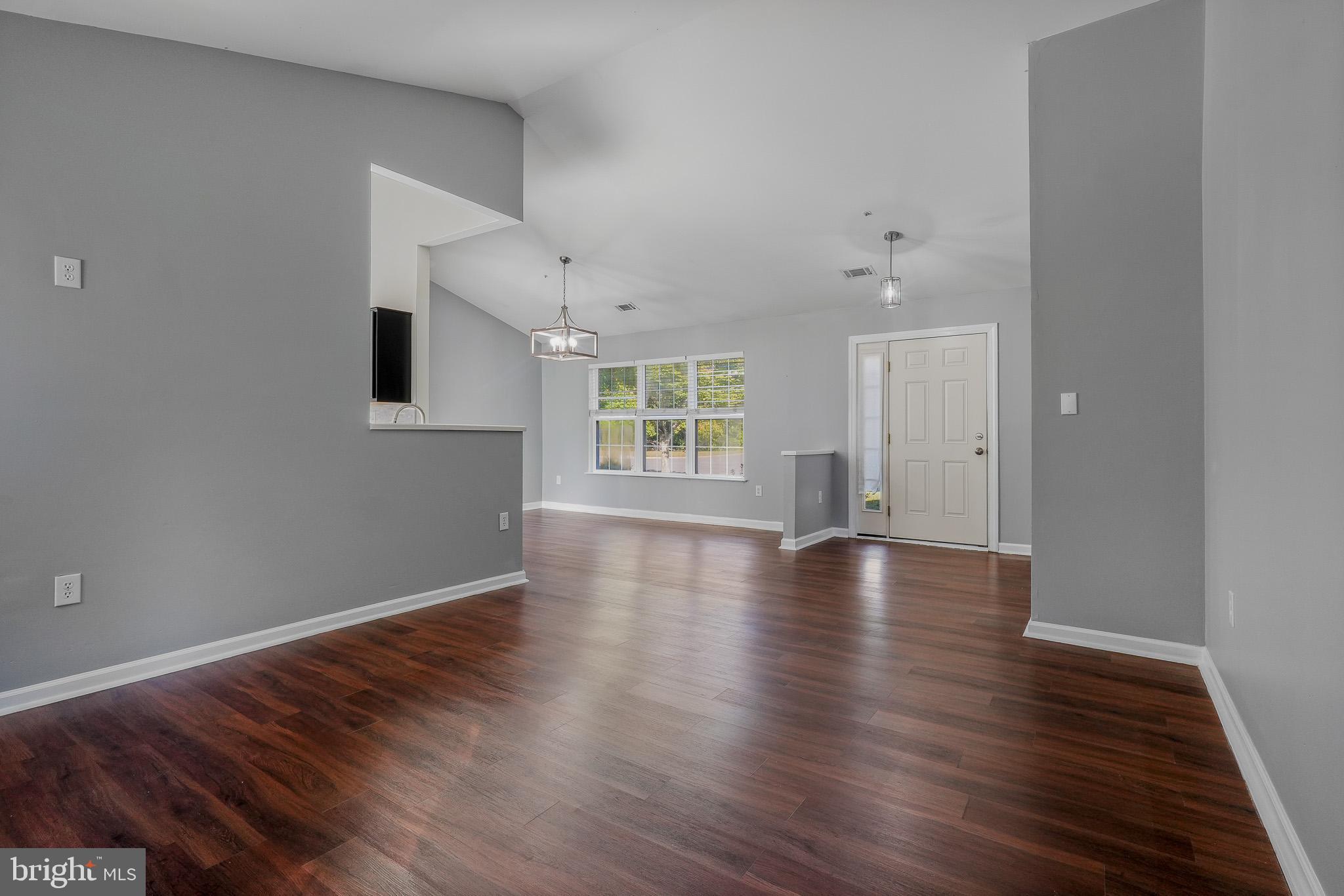 9503 Fletcher Avenue Clinton, MD 20735 - Photo 13 of 27 a view of an empty room with wooden floor and a window