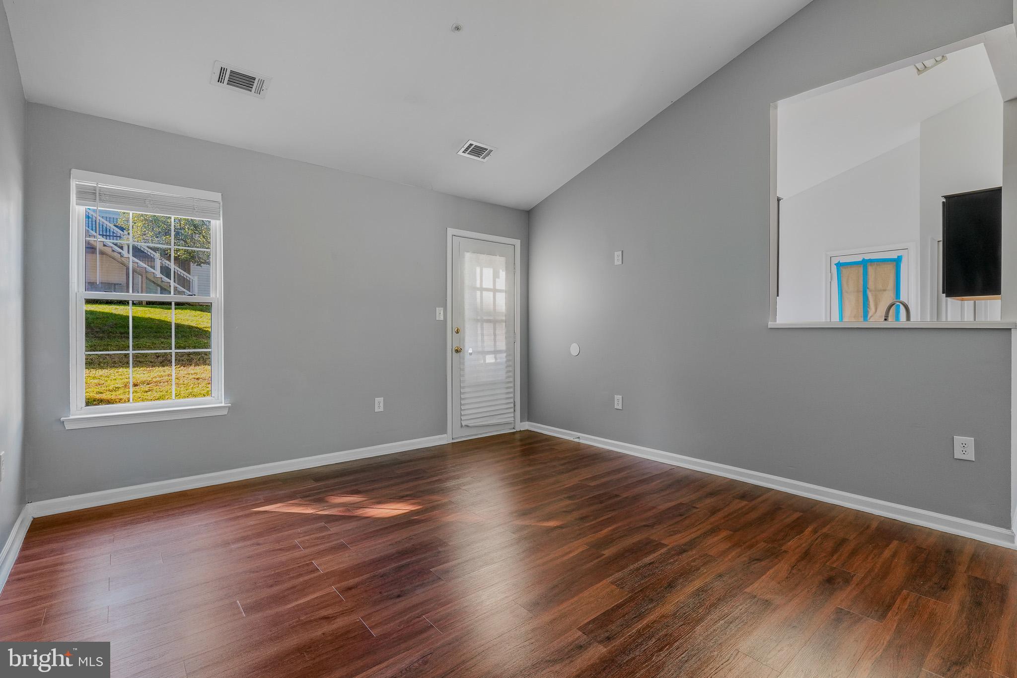 9503 Fletcher Avenue Clinton, MD 20735 - Photo 15 of 27 a view of an empty room with wooden floor and a window