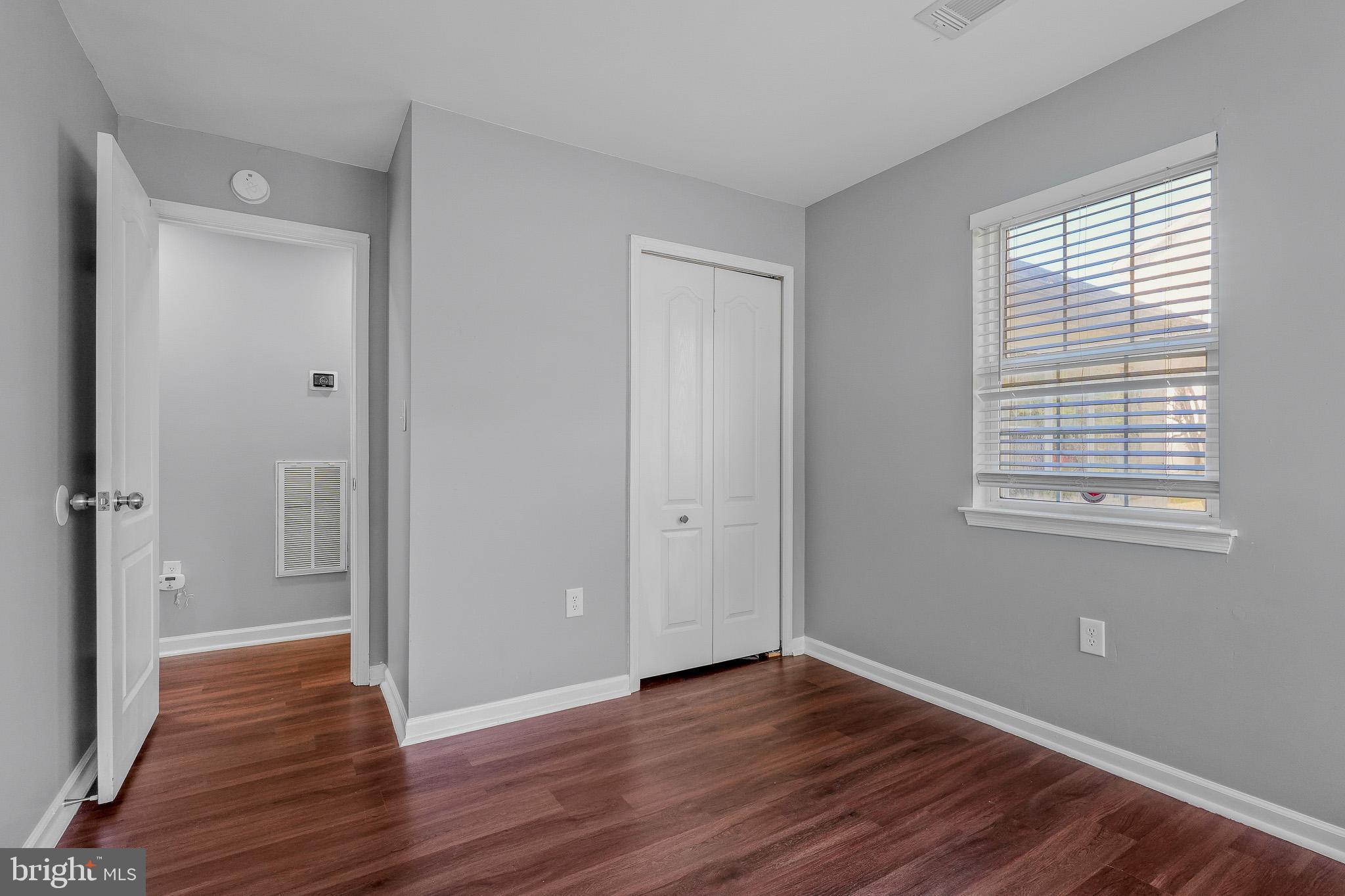 9503 Fletcher Avenue Clinton, MD 20735 - Photo 17 of 27 a view of an empty room with wooden floor and a window