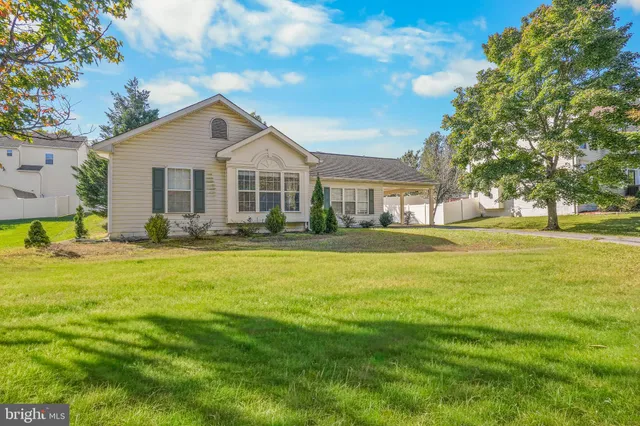 a front view of a house with a big yard