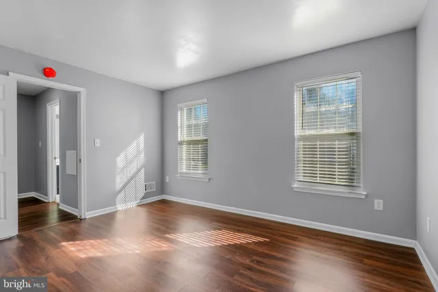a living room with hardwood flooring and a window