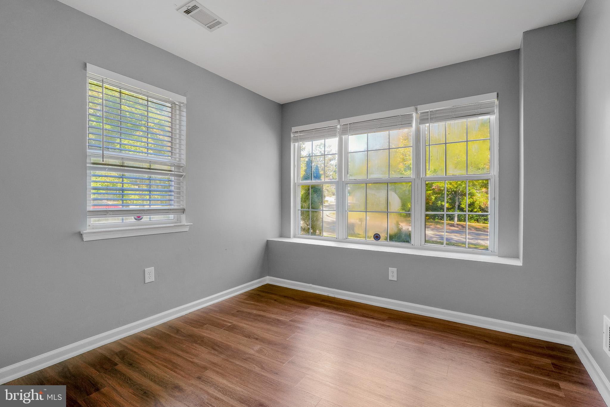 9503 Fletcher Avenue Clinton, MD 20735 - Photo 24 of 27 a view of an empty room with wooden floor and a window