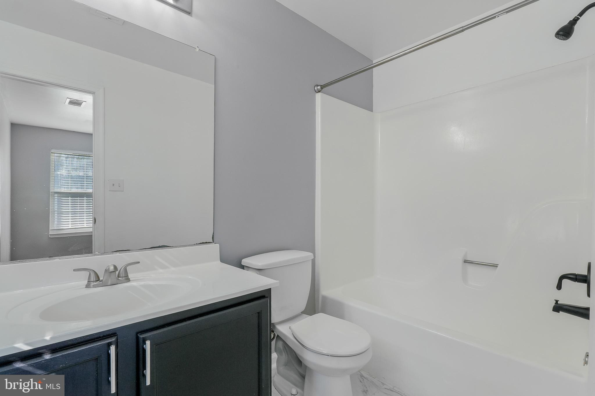 9503 Fletcher Avenue Clinton, MD 20735 - Photo 26 of 27 a bathroom with a sink toilet and vanity