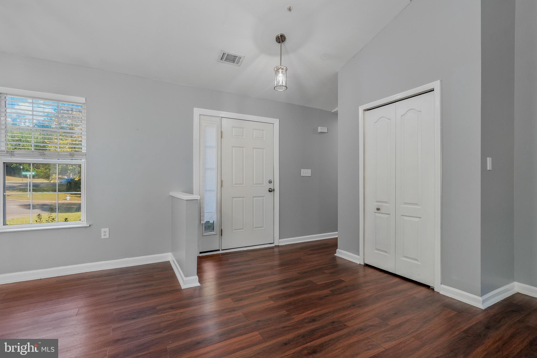 9503 Fletcher Avenue Clinton, MD 20735 - Photo 9 of 27 an empty room with wooden floor and windows