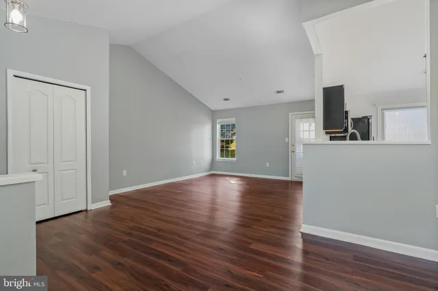 a view of a livingroom with wooden floor and white walls