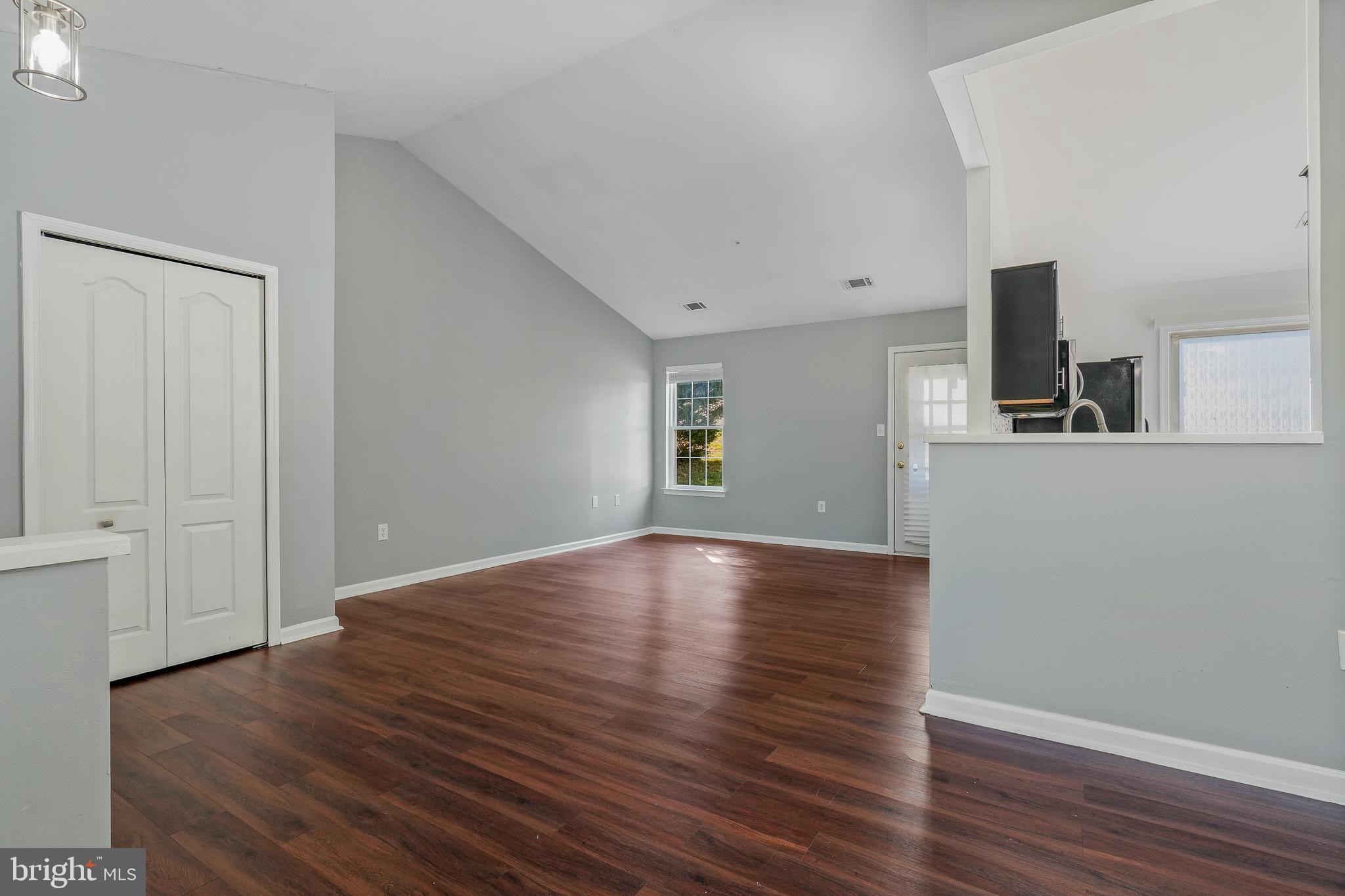 9503 Fletcher Avenue Clinton, MD 20735 - Photo 10 of 27 a view of a livingroom with wooden floor and white walls