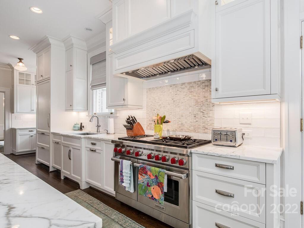 1210 Dilworth Road Charlotte, NC 28203 - Photo 18 of 39 a kitchen with stainless steel appliances a white stove top oven and sink