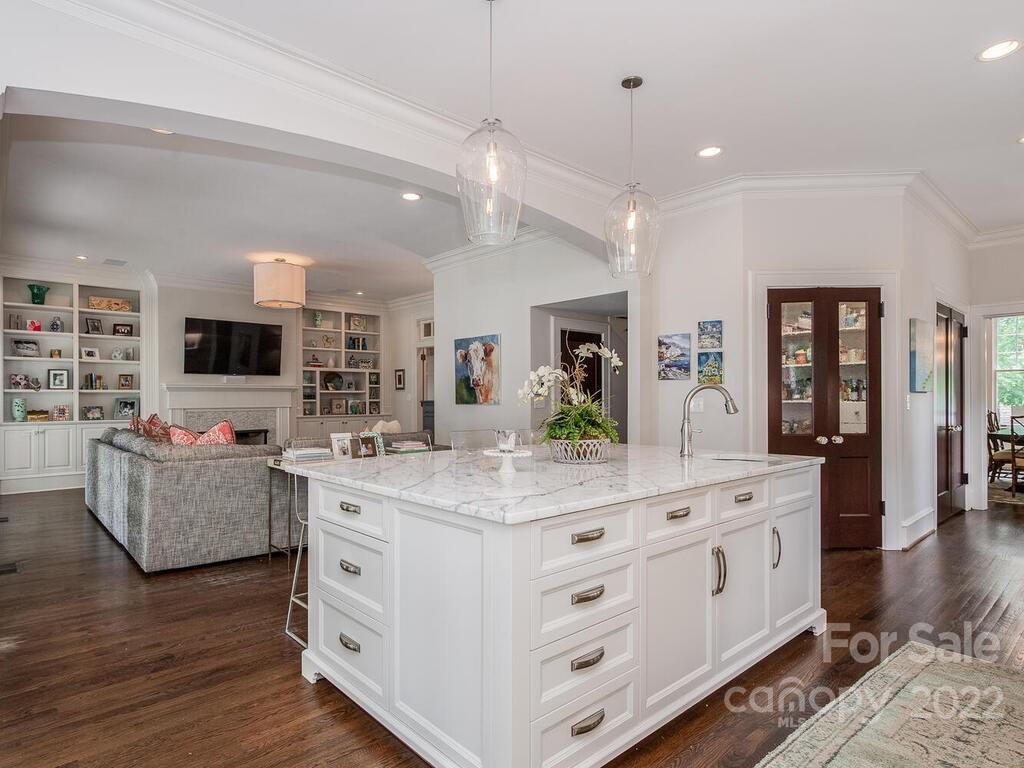 1210 Dilworth Road Charlotte, NC 28203 - Photo 19 of 39 a large kitchen with stainless steel appliances kitchen island granite countertop a stove and a wooden floors