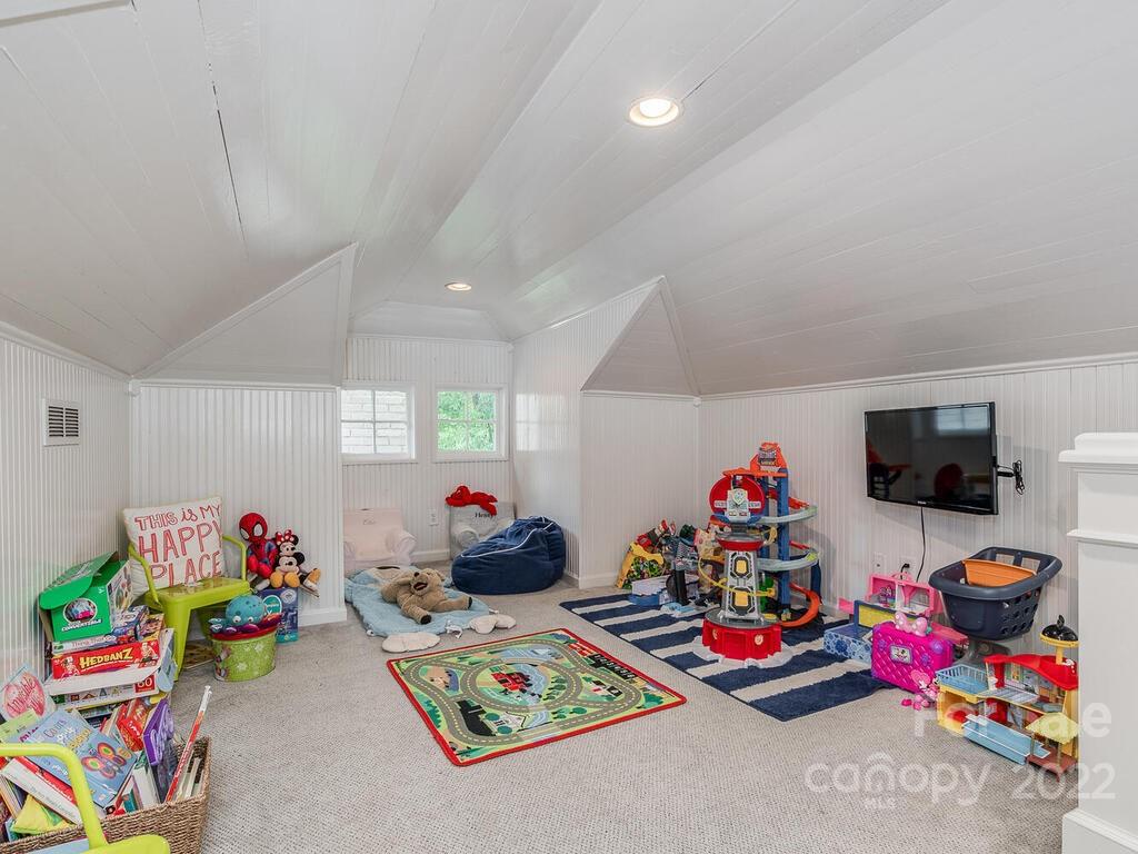 1210 Dilworth Road Charlotte, NC 28203 - Photo 27 of 39 a playing room with toys and a flat screen tv