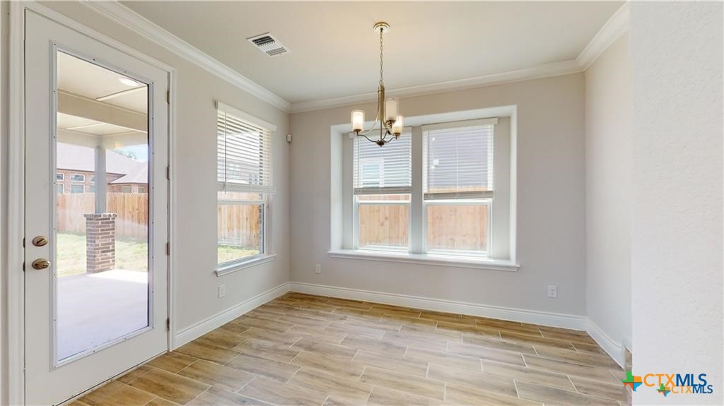 8601 Ridge Crest Drive Killeen, TX 76542 - Photo 12 of 30 a view of an empty room with a window and wooden floor