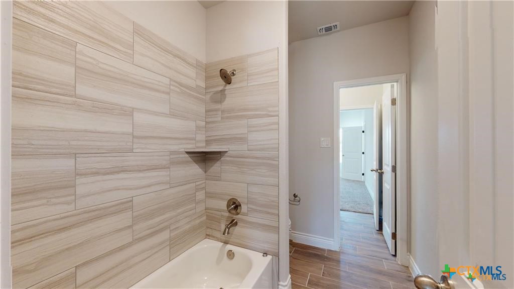 8601 Ridge Crest Drive Killeen, TX 76542 - Photo 15 of 30 a bathroom with a tub and shower