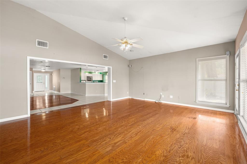 18132 Oakdale Road Odessa, FL 33556 - Photo 12 of 40 a view of an empty room with wooden floor and a window