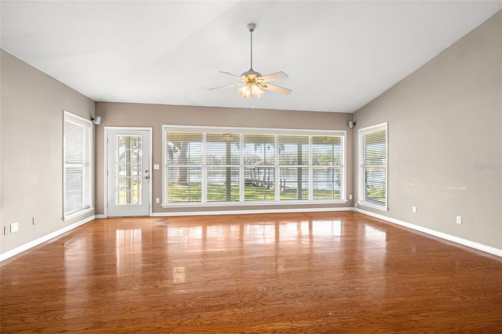 18132 Oakdale Road Odessa, FL 33556 - Photo 10 of 40 a view of an empty room with wooden floor and a window