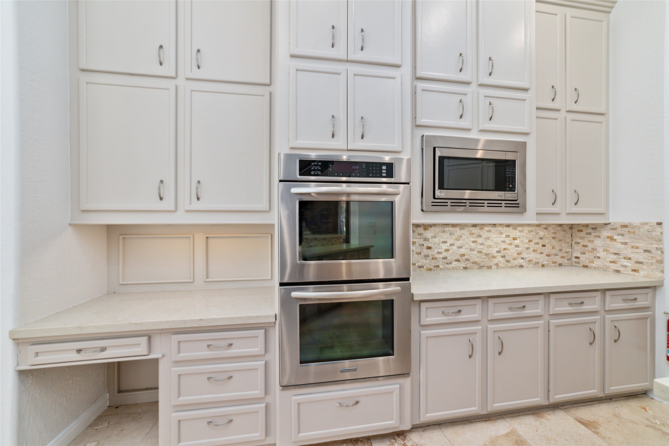 32610 Whitburn Trail Fulshear, TX 77441 - Photo 16 of 49 a kitchen with white cabinets and stainless steel appliances