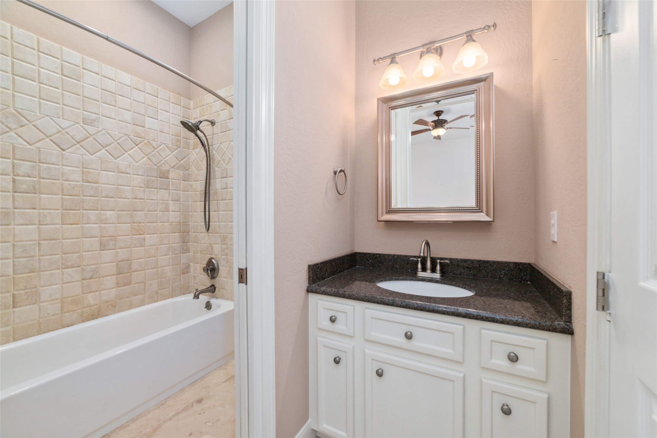 32610 Whitburn Trail Fulshear, TX 77441 - Photo 28 of 49 a bathroom with a granite countertop sink a mirror and a bathtub