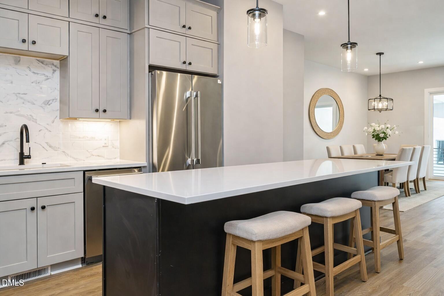 1525 Urban Trace Lane Raleigh, NC 27608 - Photo 9 of 33 a kitchen with a table chairs sink and cabinets