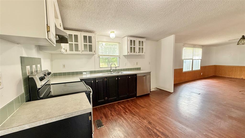 3789 Jacobs Lane Kaufman, TX 75142 - Photo 10 of 33 a kitchen with stainless steel appliances granite countertop a sink a stove and a wooden floors