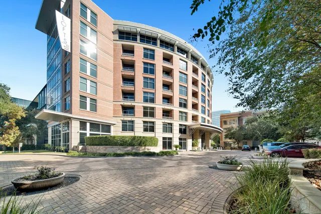 a city street lined with buildings and cars