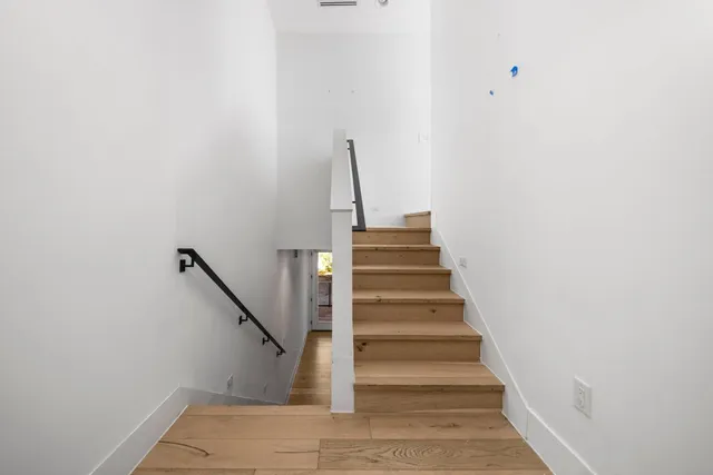 a view of a balcony with flower plants