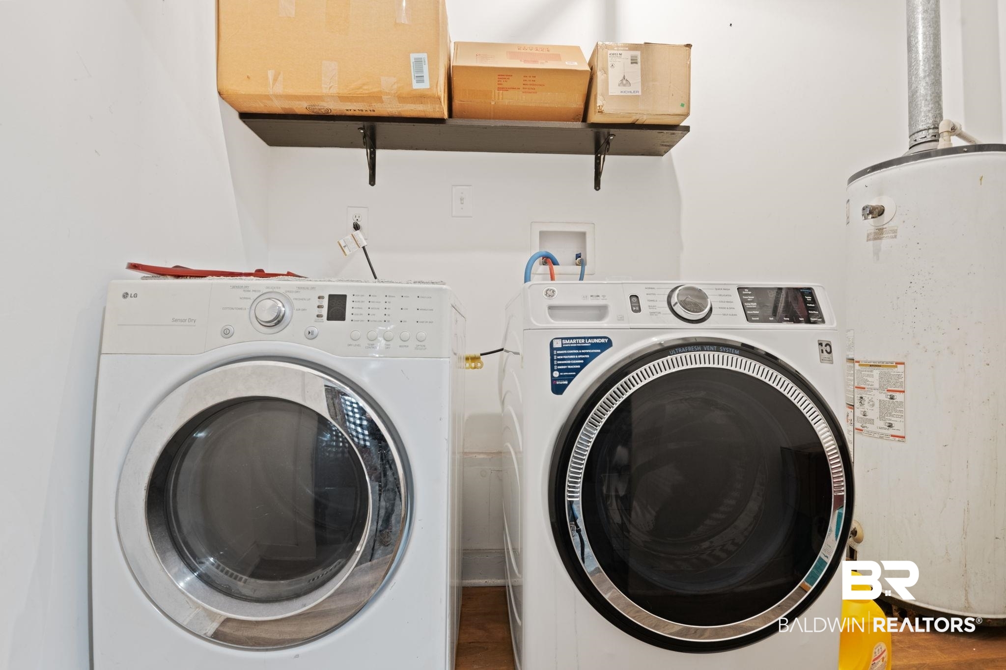 305 Alpine Street Mobile, AL 36611 - Photo 19 of 21 Clothes washing area featuring gas water heater and washing machine and clothes dryer