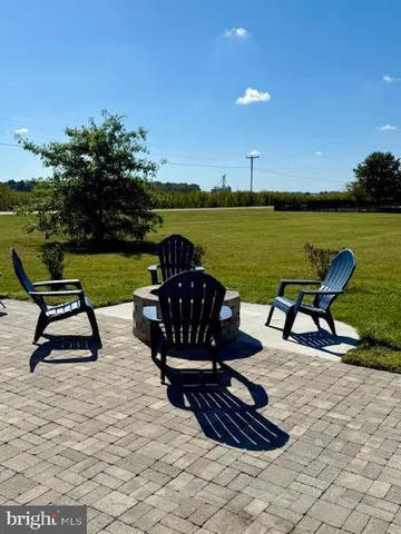 a view of a lake with a table and chairs