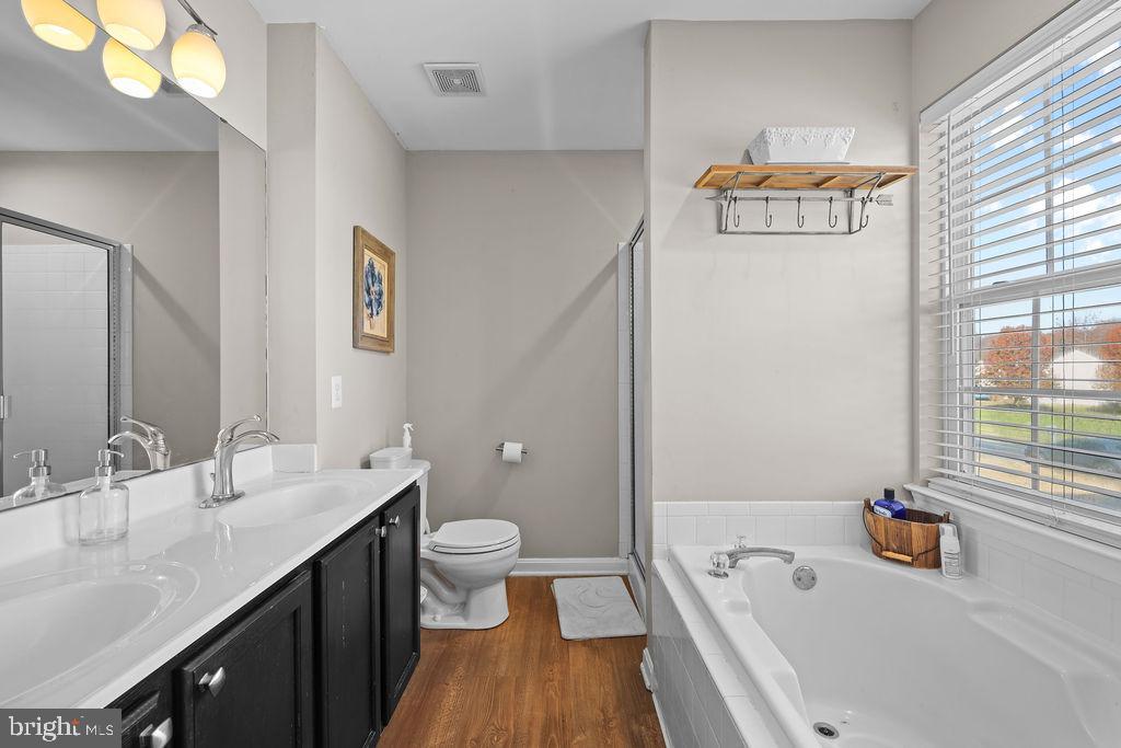 4445 Rolling Acres Drive Hurlock, MD 21643 - Photo 23 of 35 a bathroom with a sink a toilet and a bathtub