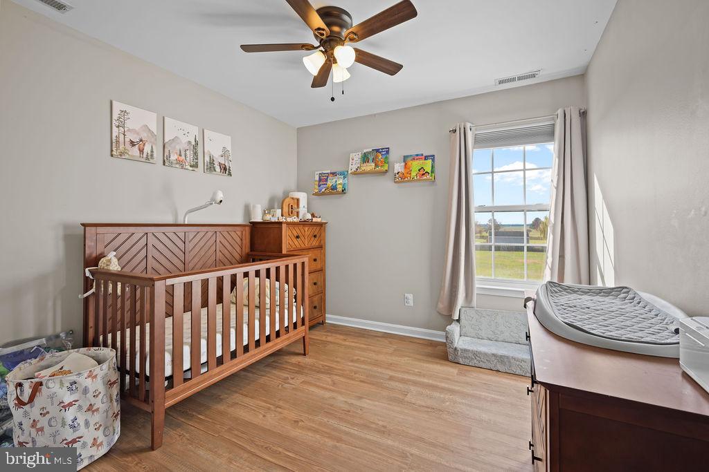4445 Rolling Acres Drive Hurlock, MD 21643 - Photo 24 of 35 a bedroom with a bed and wooden floor