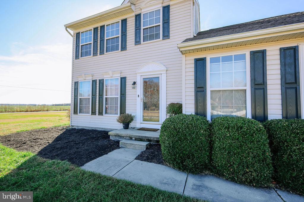 4445 Rolling Acres Drive Hurlock, MD 21643 - Photo 31 of 35 a front view of a house with a yard and ocean view
