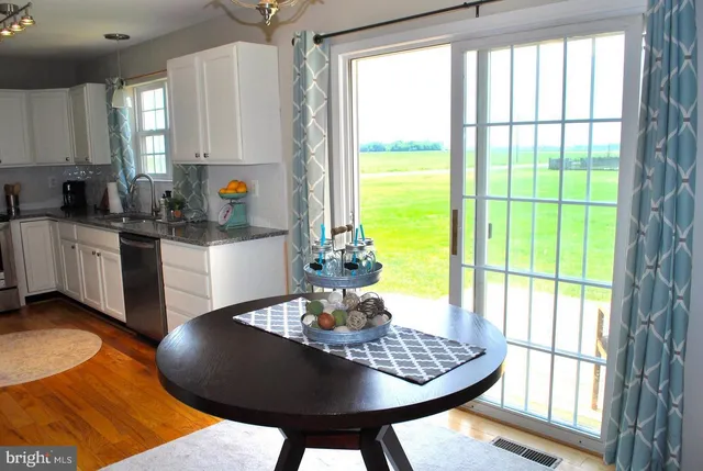 a kitchen with a table chairs and window