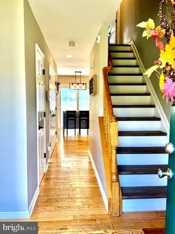 a view of entryway and hall with wooden floor